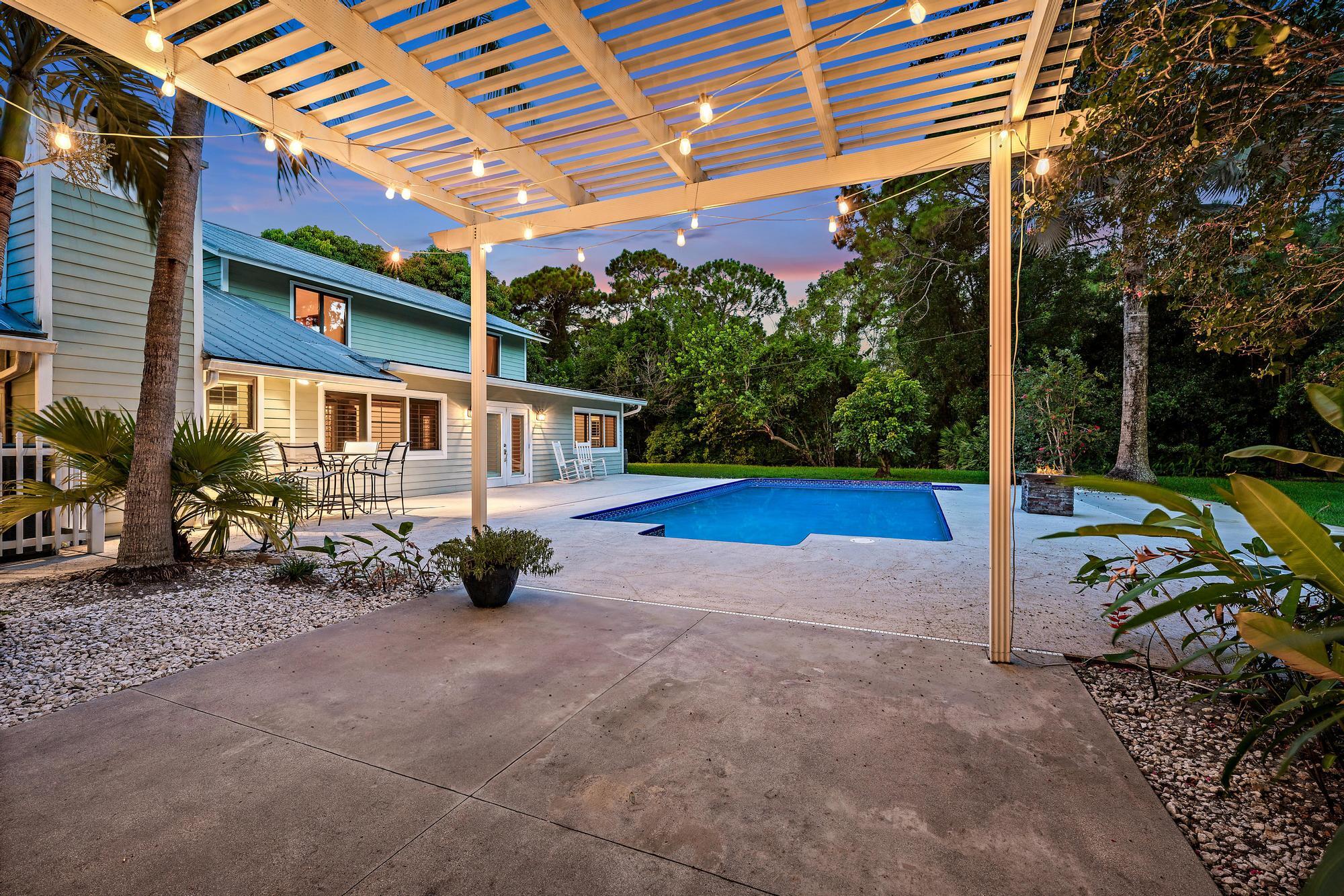 19150 Southeast Jupiter Road Jupiter, FL 33458 - Photo 30 of 43 a view of a house with backyard porch and sitting area