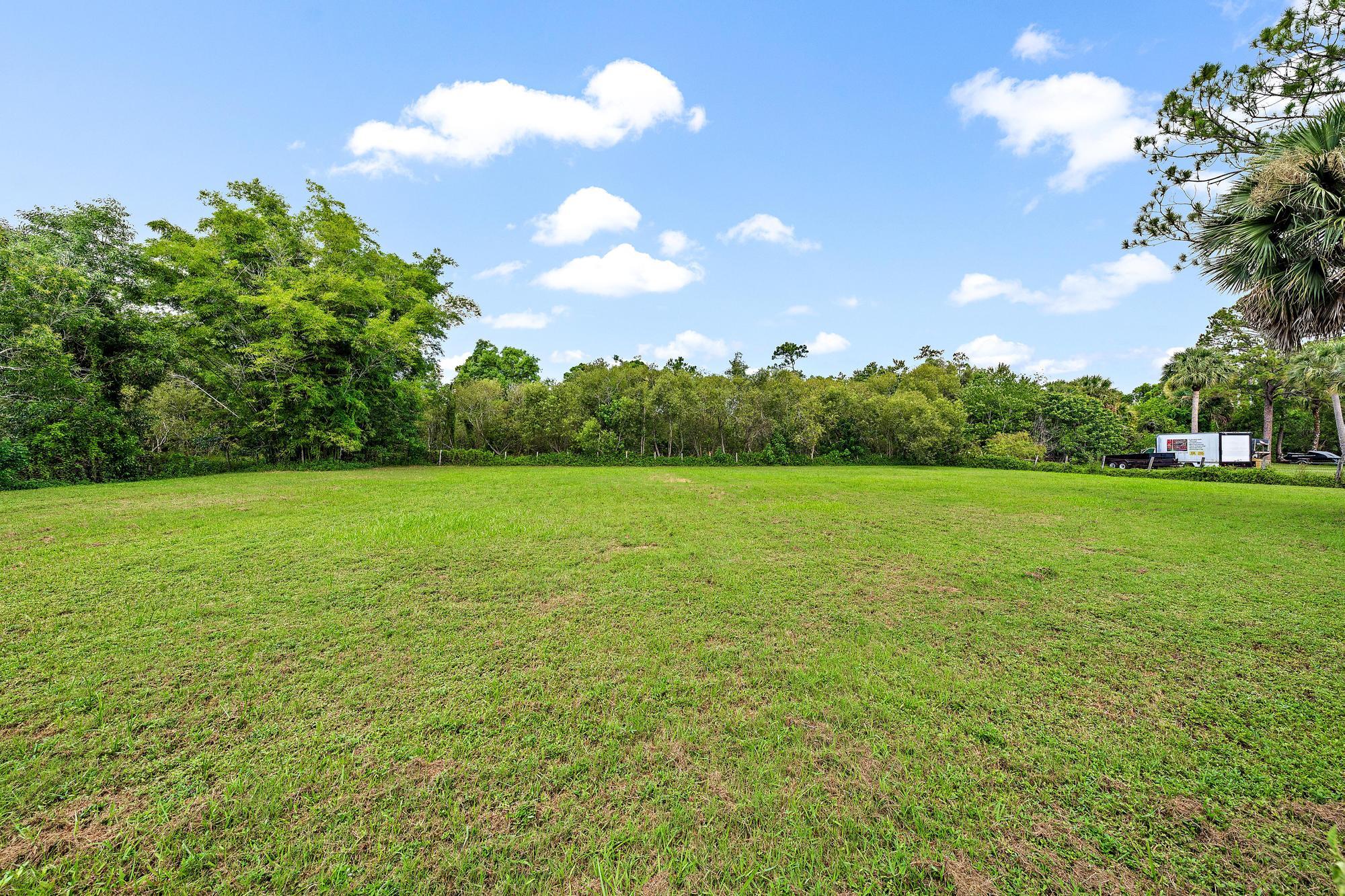 19150 Southeast Jupiter Road Jupiter, FL 33458 - Photo 32 of 43 a view of a grassy field with an trees
