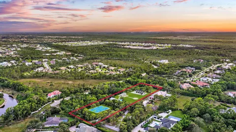 a front view of a house with yard and parking