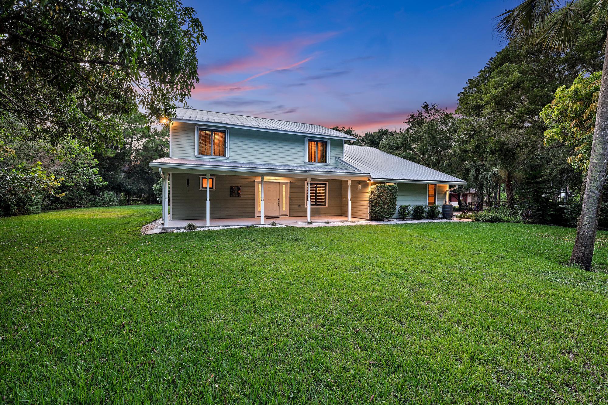 19150 Southeast Jupiter Road Jupiter, FL 33458 - Photo 5 of 43 a front view of house with yard and green space
