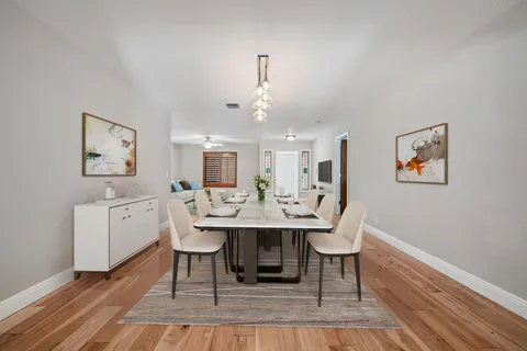 a very nice looking dining room with a table and chairs