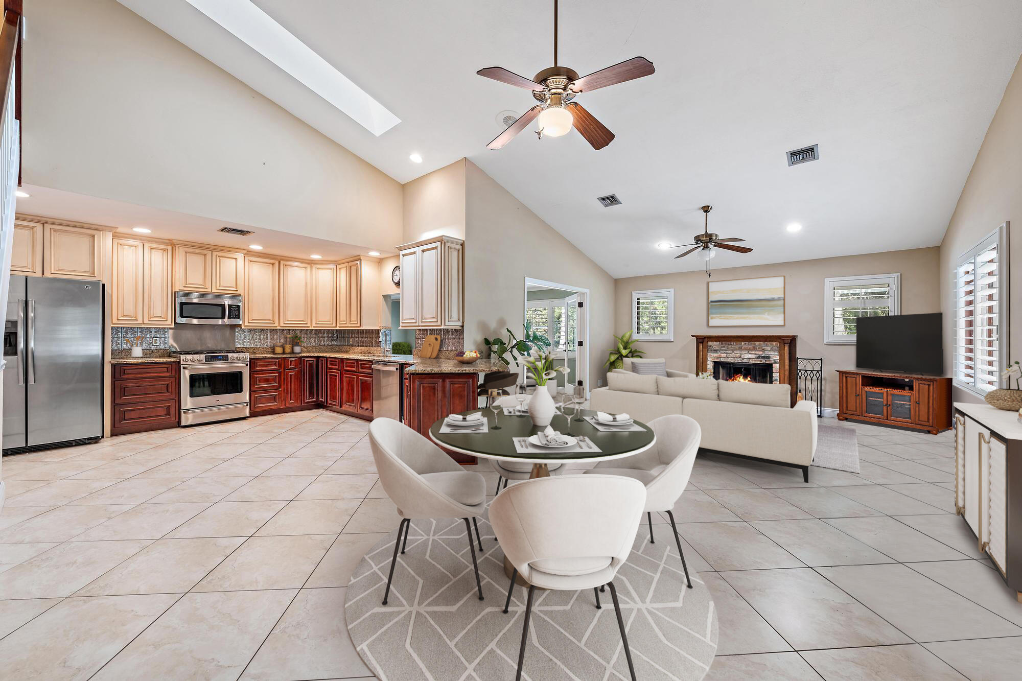 19150 Southeast Jupiter Road Jupiter, FL 33458 - Photo 9 of 43 a kitchen with stainless steel appliances kitchen island granite countertop a stove a sink a dining table and chairs with wooden floor