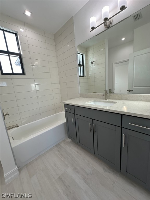 7464 Rockefeller Drive Naples, FL 34119 - Photo 12 of 22 a bathroom with a tub sink and mirror