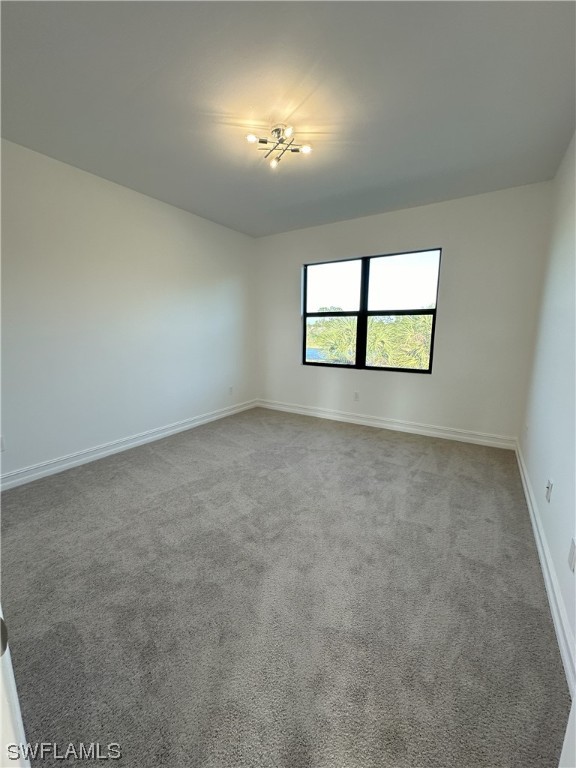 7464 Rockefeller Drive Naples, FL 34119 - Photo 13 of 22 an empty room with a empty space and windows