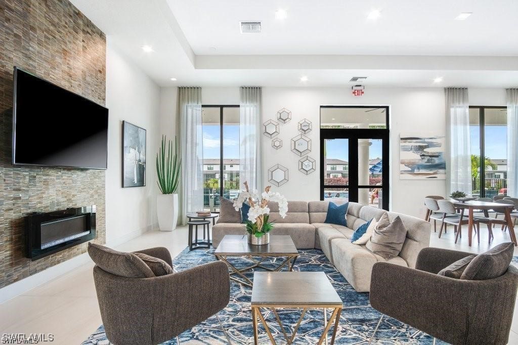 7464 Rockefeller Drive Naples, FL 34119 - Photo 17 of 22 a living room with fireplace furniture and a flat screen tv