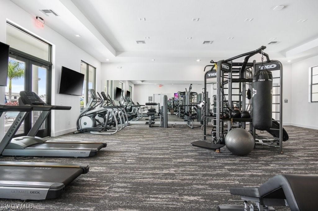 7464 Rockefeller Drive Naples, FL 34119 - Photo 18 of 22 a view of a room with gym equipment