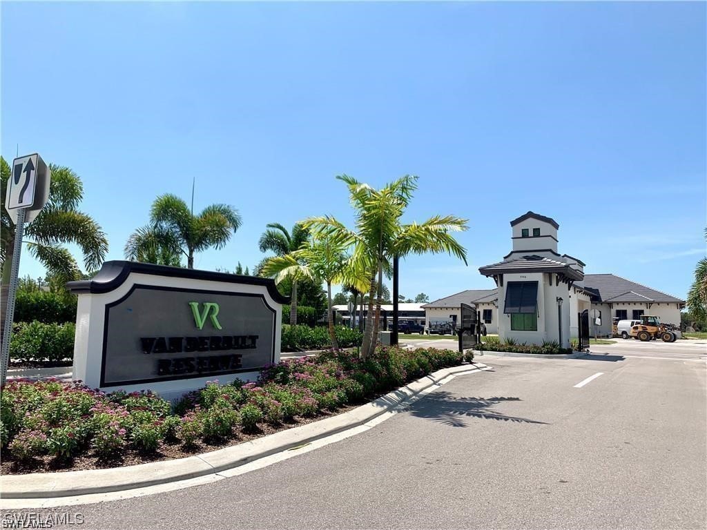 7464 Rockefeller Drive Naples, FL 34119 - Photo 21 of 22 a front view of a house with a garden