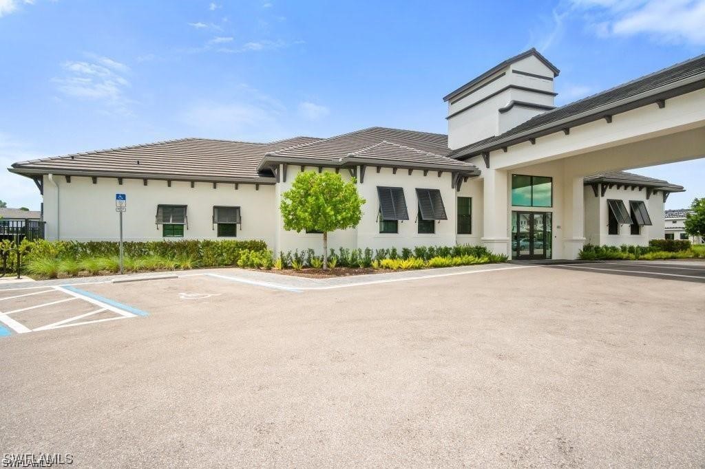 7464 Rockefeller Drive Naples, FL 34119 - Photo 22 of 22 front view of a house with a small yard