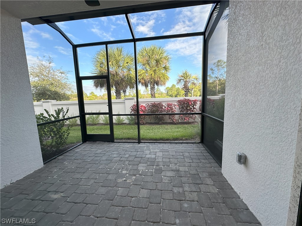 7464 Rockefeller Drive Naples, FL 34119 - Photo 4 of 22 a view of a garden with a bench in front of it
