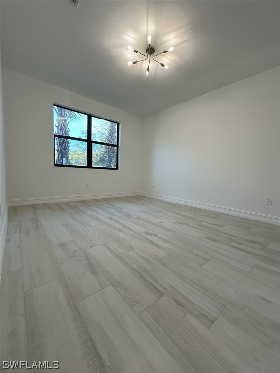 7464 Rockefeller Drive Naples, FL 34119 - Photo 5 of 22 an empty room with a empty space and windows