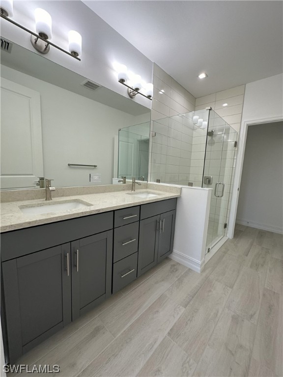 7464 Rockefeller Drive Naples, FL 34119 - Photo 6 of 22 a spacious bathroom with a double vanity sink a large mirror and a shower