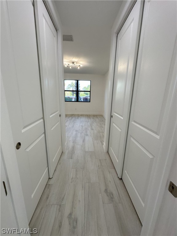 7464 Rockefeller Drive Naples, FL 34119 - Photo 7 of 22 a view of hallway with wooden floor