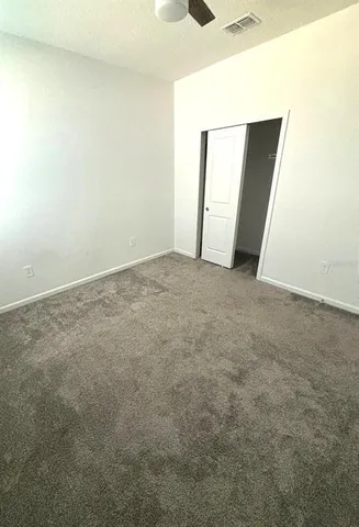 an empty room with windows and closet