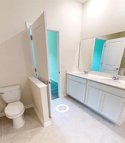a bathroom with a toilet sink and mirror