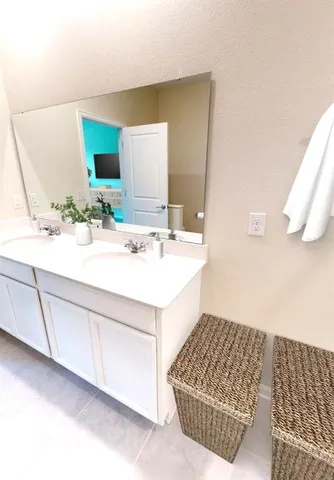 a bathroom with a sink vanity and mirror