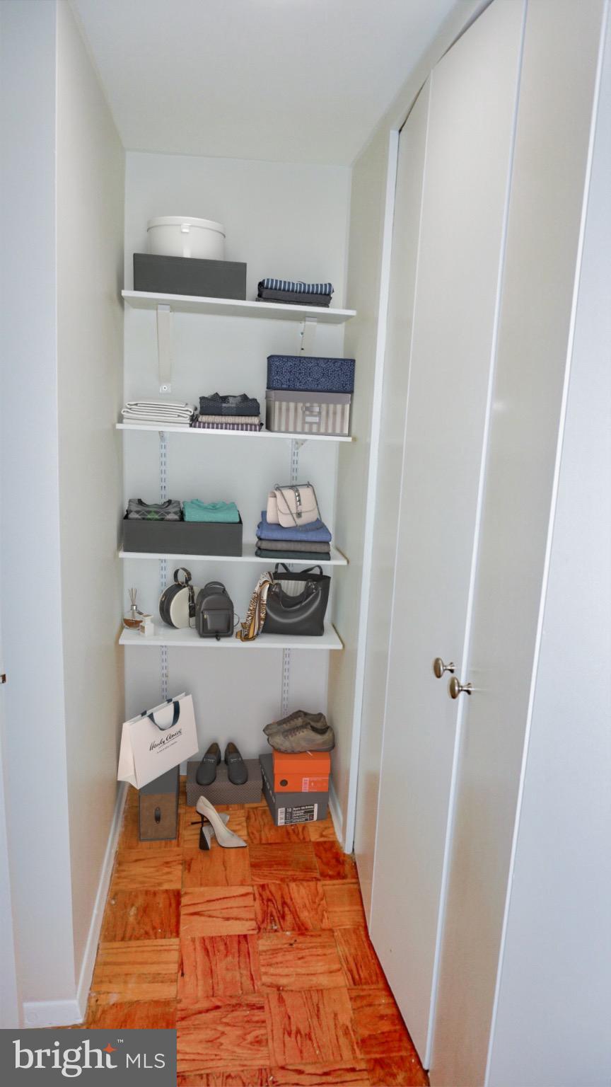 2030 F Street Northwest, Unit 508 Washington, DC 20006 - Photo 11 of 12 a room with white cabinets and wooden floor