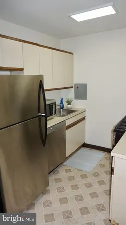 a kitchen with stainless steel appliances granite countertop a refrigerator sink and cabinets