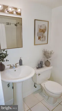 a bathroom with a sink mirror and toilet