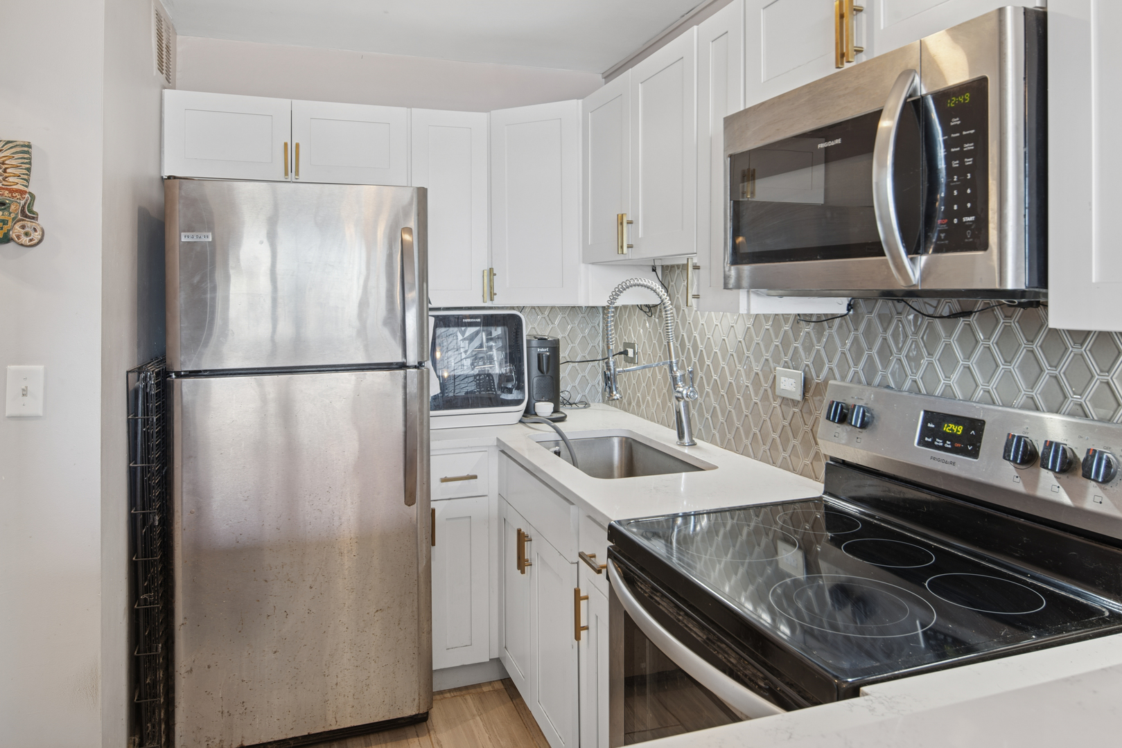 5455 North Sheridan Road, Unit 2805 Chicago, IL 60640 - Photo 11 of 20 a kitchen with stainless steel appliances granite countertop a refrigerator stove top oven and sink