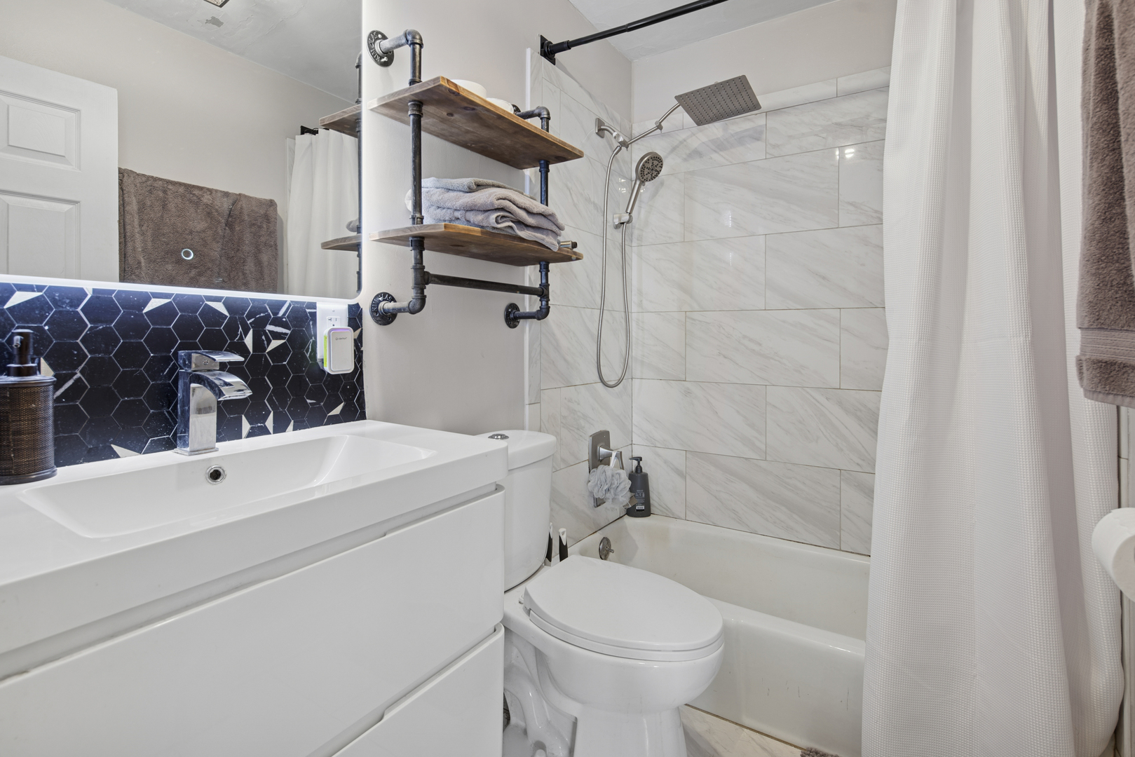 5455 North Sheridan Road, Unit 2805 Chicago, IL 60640 - Photo 14 of 20 a bathroom with a sink a toilet and shower