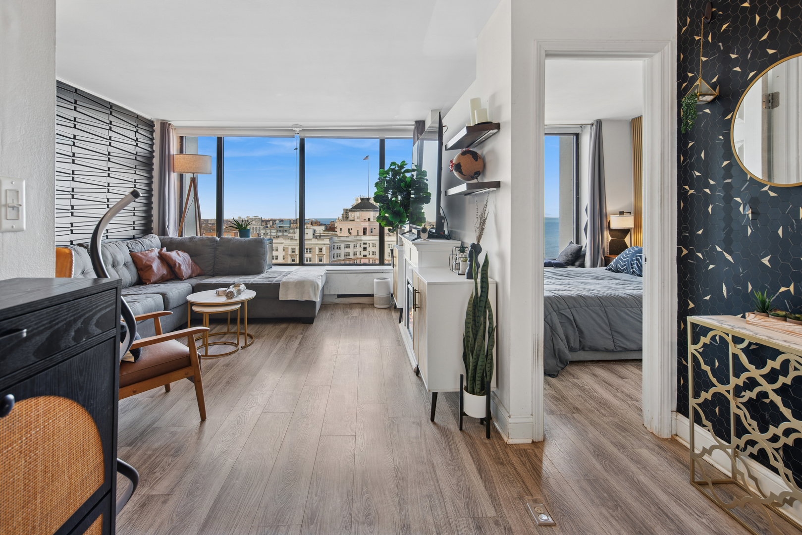 5455 North Sheridan Road, Unit 2805 Chicago, IL 60640 - Photo 2 of 20 a living room with furniture and a wooden floor