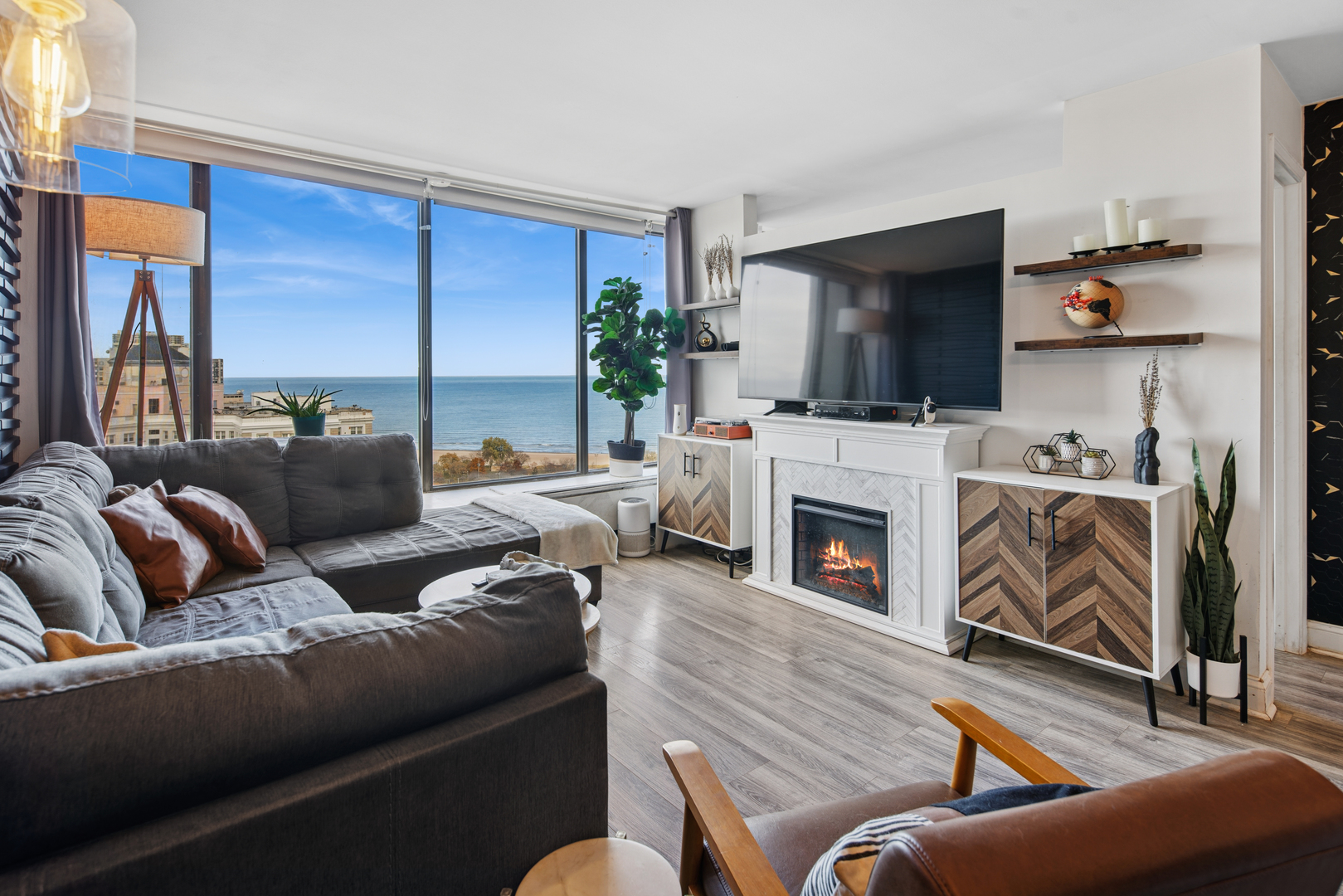5455 North Sheridan Road, Unit 2805 Chicago, IL 60640 - Photo 4 of 20 a living room with furniture a fireplace and a flat screen tv