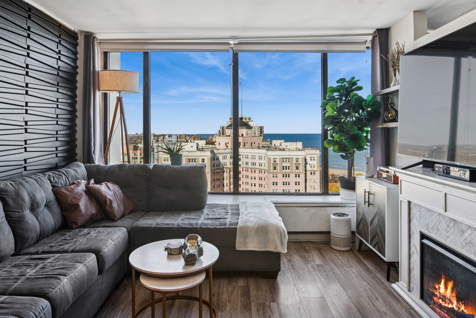 5455 North Sheridan Road, Unit 2805 Chicago, IL 60640 - Photo 5 of 20 a living room with furniture and a fireplace