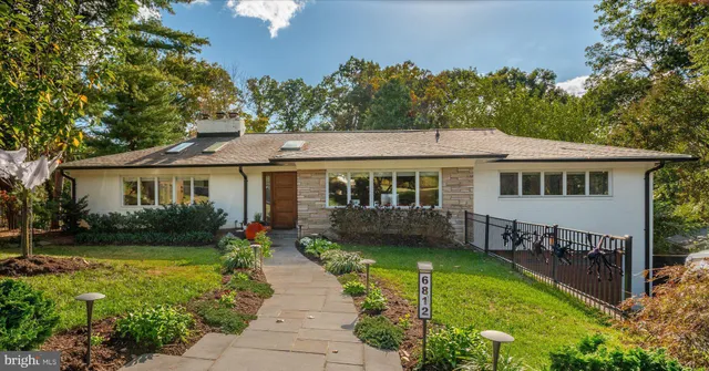 a front view of a house with a yard table and chairs