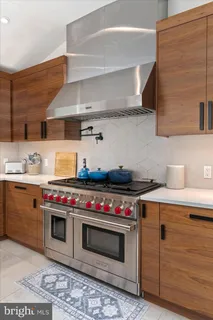a kitchen with stainless steel appliances a stove and cabinets