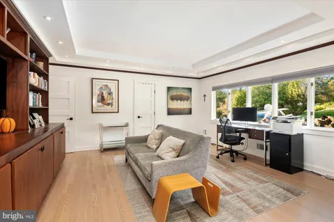 a living room with furniture large window and a flat screen tv