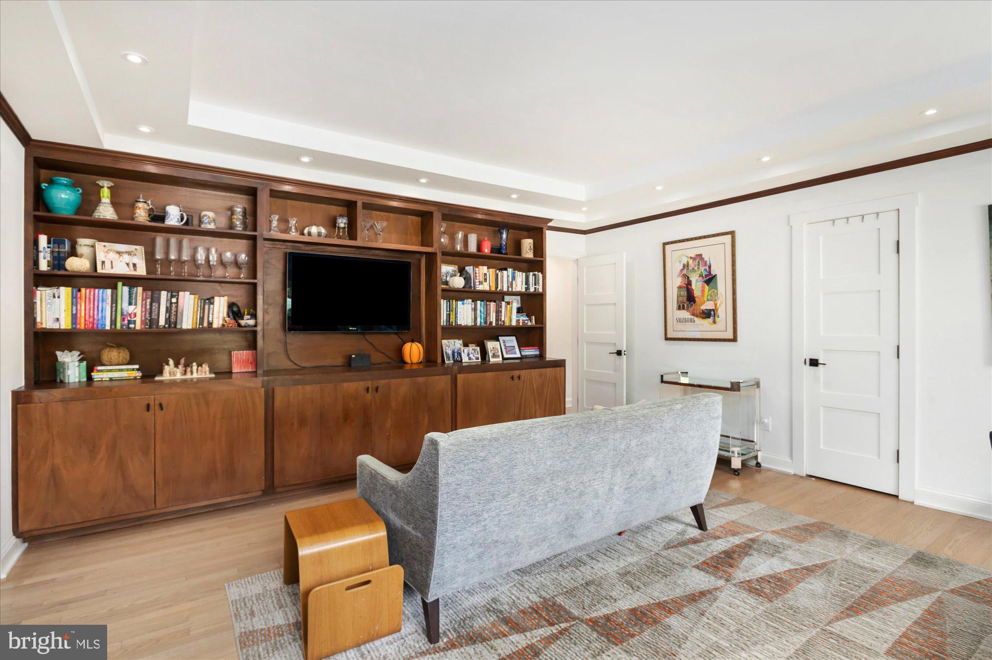 6812 Tulip Hill Terrace Bethesda, MD 20816 - Photo 13 of 35 a living room with furniture and a flat screen tv
