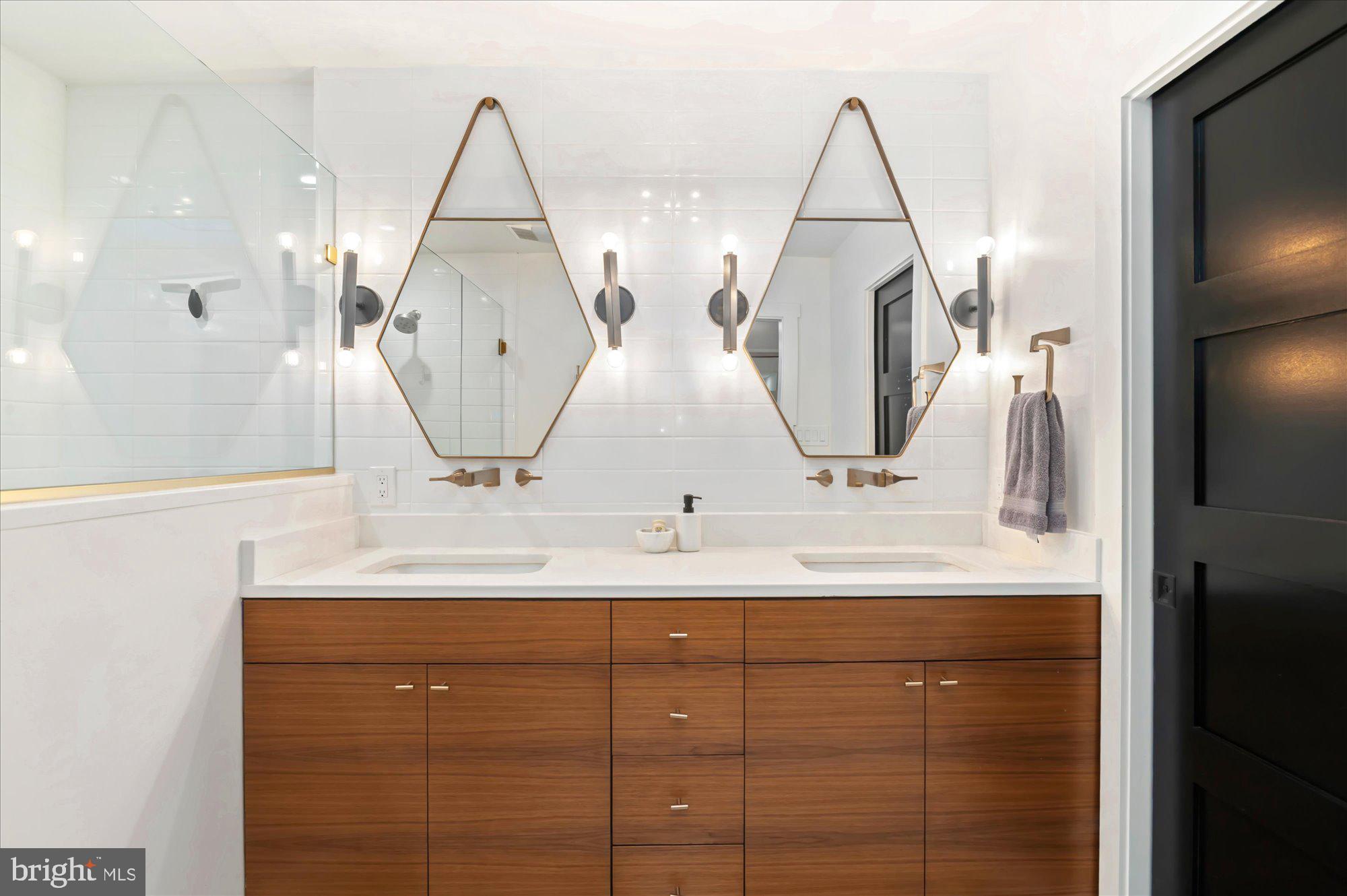 6812 Tulip Hill Terrace Bethesda, MD 20816 - Photo 18 of 35 a bathroom with a double vanity sink and a mirror