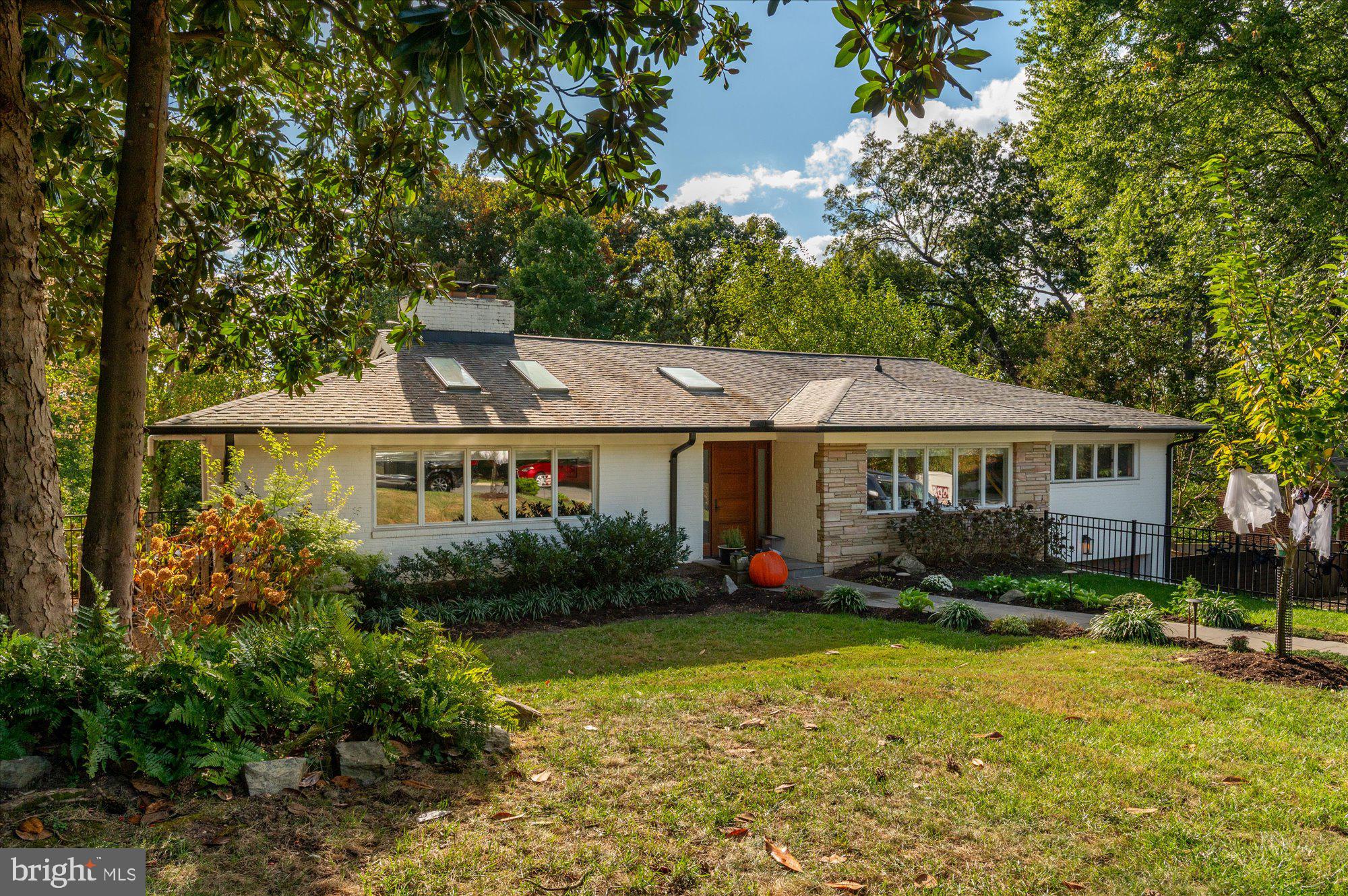 6812 Tulip Hill Terrace Bethesda, MD 20816 - Photo 2 of 35 a front view of a house with garden