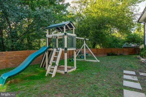 a view of outdoor space with playground and green space