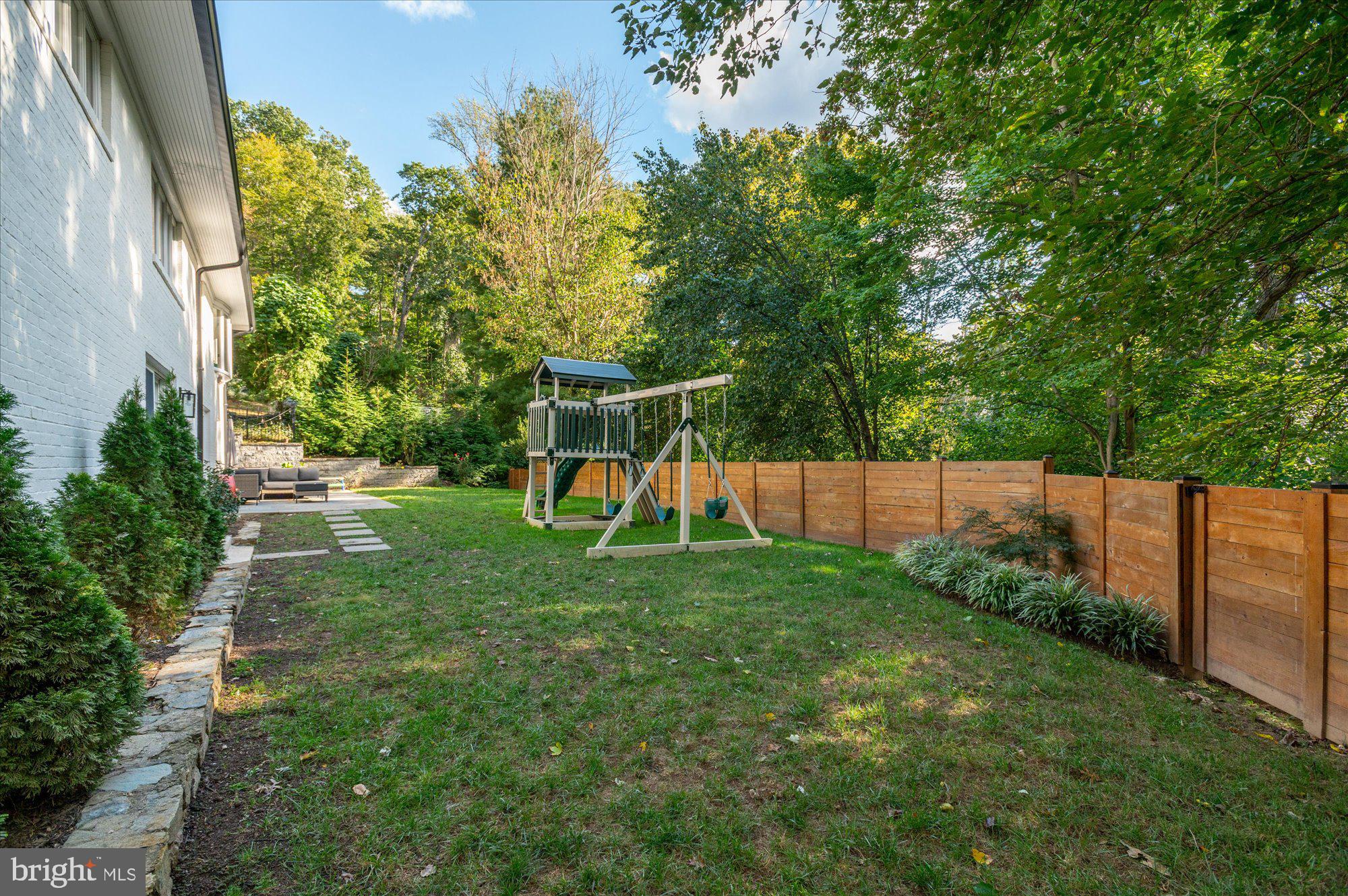6812 Tulip Hill Terrace Bethesda, MD 20816 - Photo 29 of 35 a view of a yard with a slide