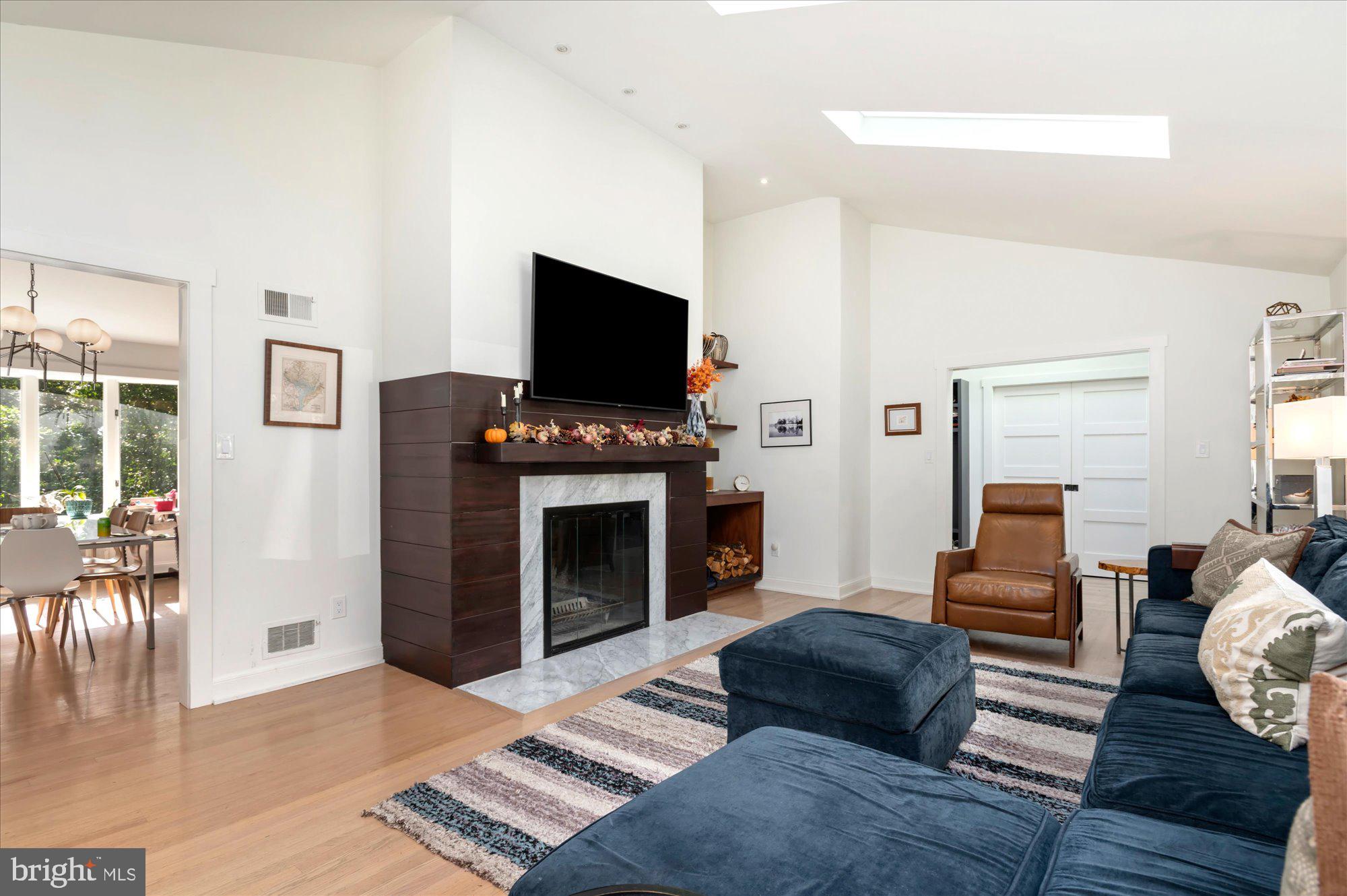 6812 Tulip Hill Terrace Bethesda, MD 20816 - Photo 6 of 35 a living room with furniture a flat screen tv and a fireplace