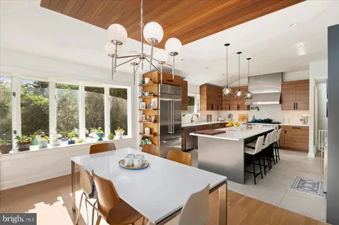 a kitchen with stainless steel appliances granite countertop a sink a stove and a refrigerator