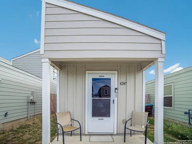 a front view of a house having outdoor seating