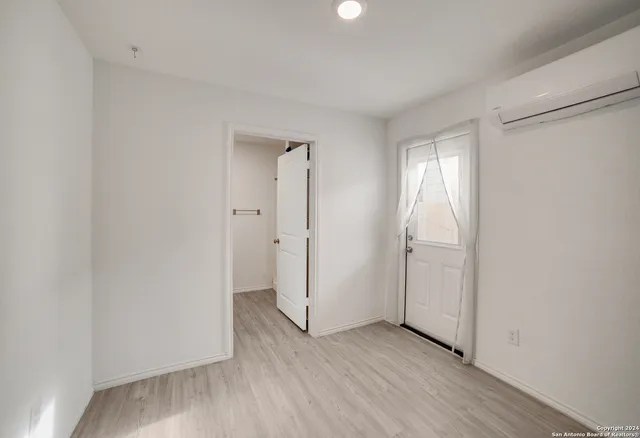 an empty room with wooden floor