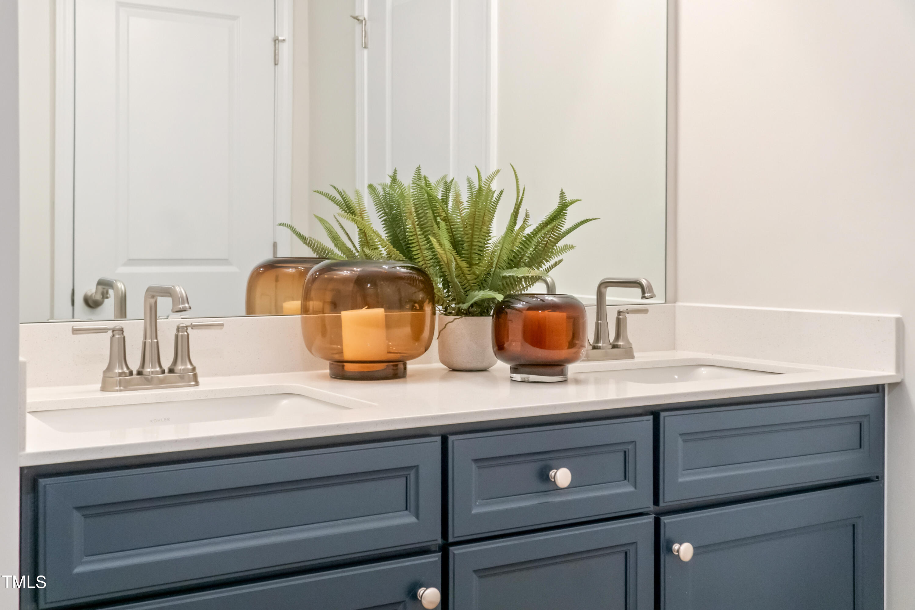4909 Caddis Bend Raleigh, NC 27604 - Photo 19 of 30 a bathroom with a sink a vanity and a potted plant