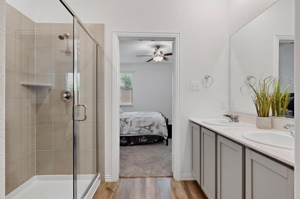 444 Ranchito Pass Fort Worth, TX 76052 - Photo 10 of 24 a en suite bathroom with a granite countertop sink and a mirror