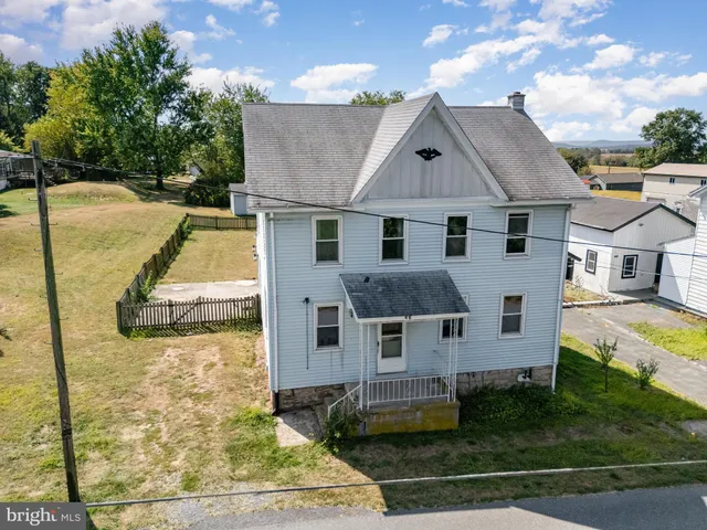 a aerial view of a house with yard