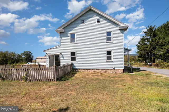 a view of a house with wooden fence