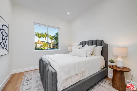 a bathroom with a toilet a sink and glass door