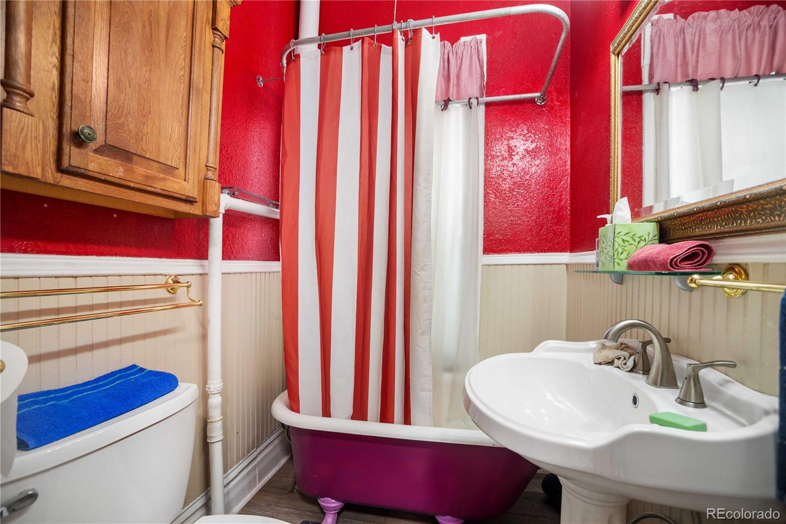 2623 Stout Street Denver, CO 80205 - Photo 16 of 39 a bathroom with a sink a toilet and a mirror