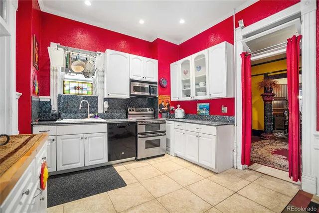 a kitchen with stainless steel appliances kitchen island granite countertop a stove a sink and dishwasher