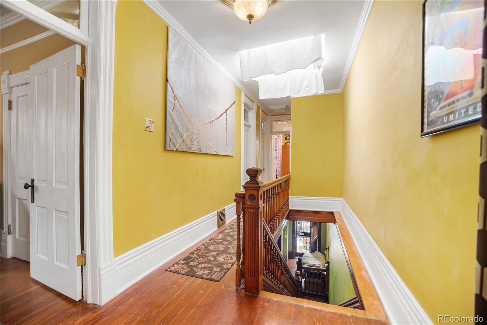 2623 Stout Street Denver, CO 80205 - Photo 31 of 39 a view of a hallway with wooden floor and staircase
