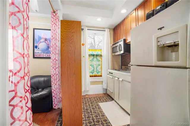 a kitchen with stainless steel appliances granite countertop a sink a stove and a window