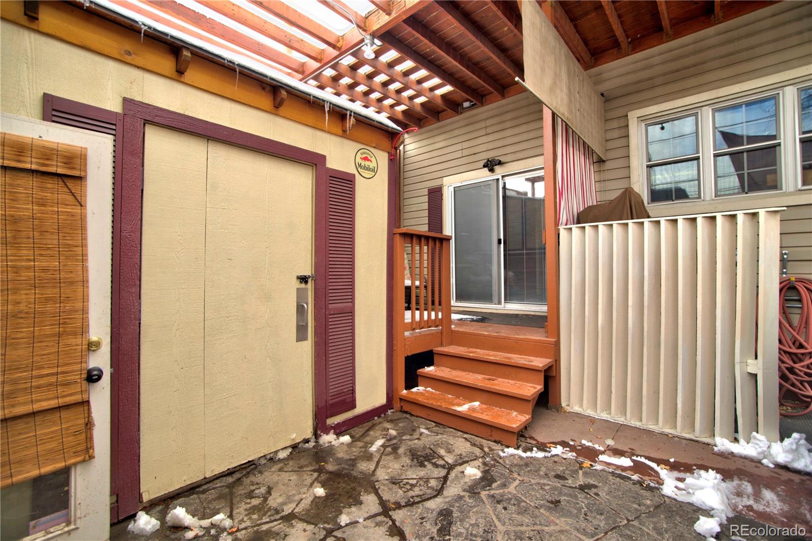 2623 Stout Street Denver, CO 80205 - Photo 37 of 39 a view of a house with a door and wooden walls