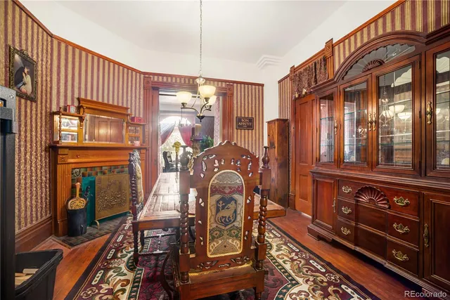 a living room with furniture flowerpot and wooden floor
